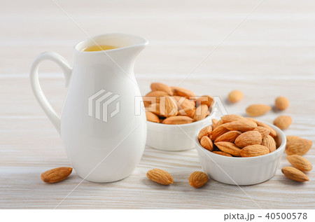 Almond oil and almonds on a white background. Almond oil and almonds on a white background. 40500578