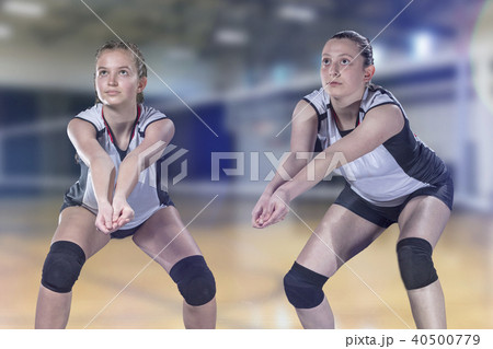 Female professional volleyball player on volleyball court Female professional volleyball player on volleyball court 40500779