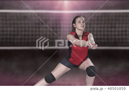 Female professional volleyball player on volleyball court Female professional volleyball player on volleyball court 40501050