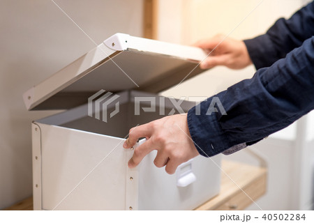 Male hand opening white box. Home decoration 40502284