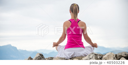 Woman meditating at the lake Woman meditating at the lake 40503226