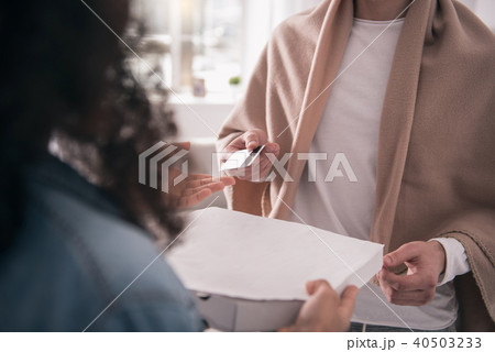 Close up of a credit card given to the courier Close up of a credit card given to the courier 40503233