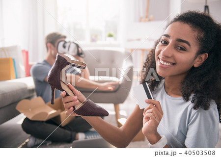 Happy pleasant woman buying shoes Happy pleasant woman buying shoes 40503508