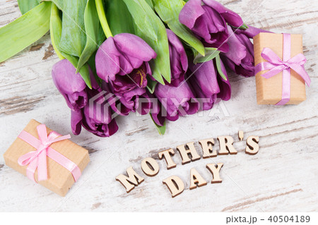 Purple tulips and gifts for mother's day on boards 40504189