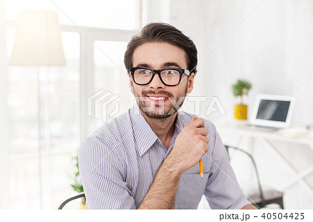 Joyful employer holding a pencil 40504425