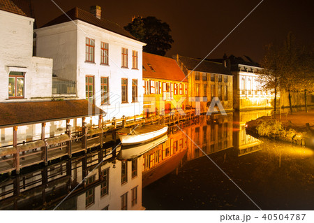 Bruges by night. Calm Dijver canal with boat in the dock. Belgium Bruges by night. Calm Dijver canal with boat in the dock. Belgium 40504787