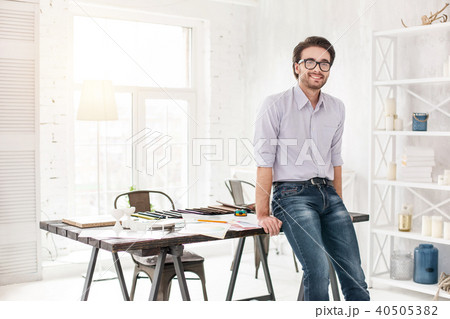 Alert businessman standing near the table 40505382