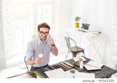 Content employee talking on the phone Content employee talking on the phone 40505399