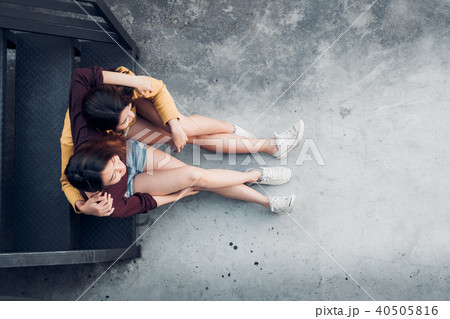 Two female lesbian lgbt couple sitting at rooftop 40505816