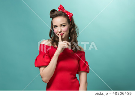 Beautiful young woman with pinup make-up and hairstyle. Studio shot on white background Beautiful young woman with pinup make-up and hairstyle. Studio shot on white background 40506459