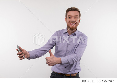 Cheerful young man showing OK sign Cheerful young man showing OK sign 40507967