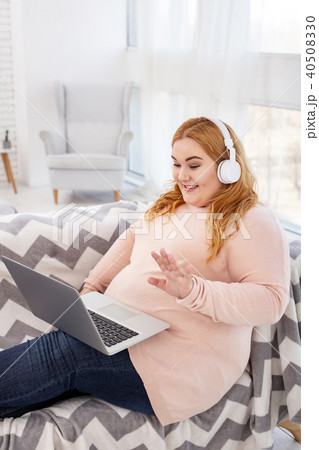 Happy plump woman listening to music Happy plump woman listening to music 40508330