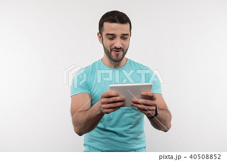 Cheerful happy man using modern technology Cheerful happy man using modern technology 40508852