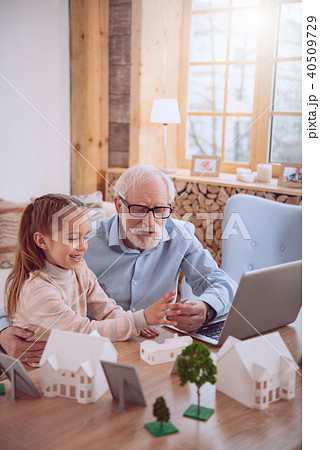 Positive aged man spending time with his granddaughter Positive aged man spending time with his granddaughter 40509729