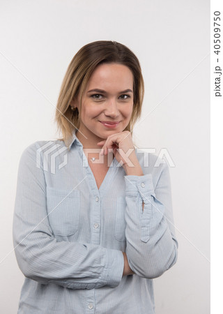 Happy delighted woman touching her chin Happy delighted woman touching her chin 40509750