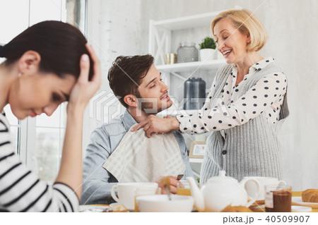 Cheerful positive woman smiling to her son Cheerful positive woman smiling to her son 40509907
