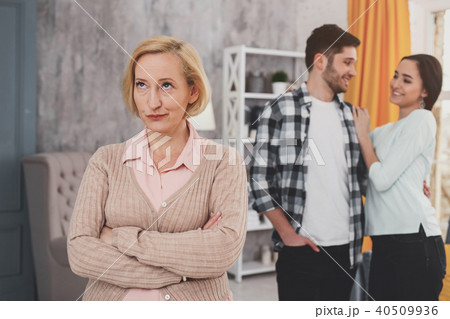 Dissatisfied senior woman standing at home 40509936