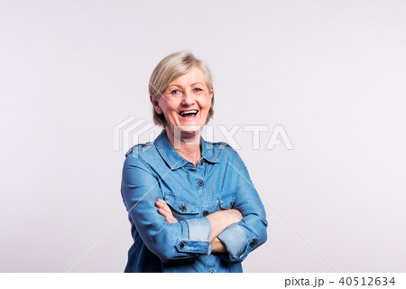 Portrait of a happy senior woman in studio, on a white background. Portrait of a happy senior woman in studio, on a white background. 40512634