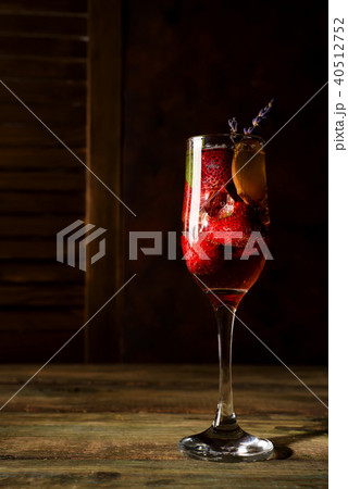 strawberry jive cocktail with ice and lavender on wooden background strawberry jive cocktail with ice and lavender on wooden background 40512752