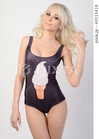 beautiful slim girl in a black bathing suit poses 40513419