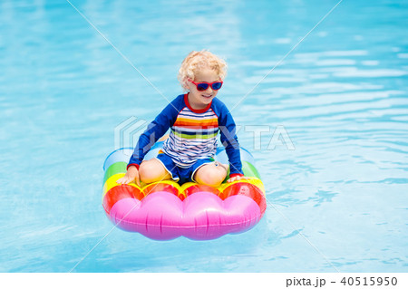 Child on inflatable float in swimming pool. 40515950