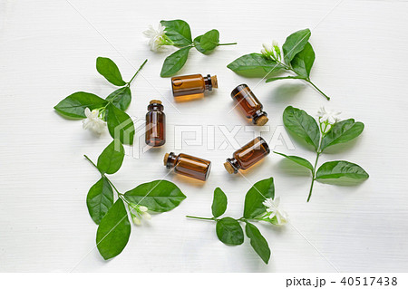 Dark brown Bottles of essential oil with jasmine. Dark brown Bottles of essential oil with jasmine. 40517438