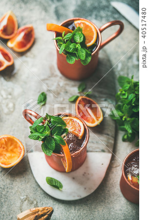 Blood orange Moscow mule alcohol cocktails in metal mugs 40517480