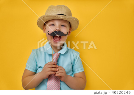 Boy playing and holding paper mustache 40520249
