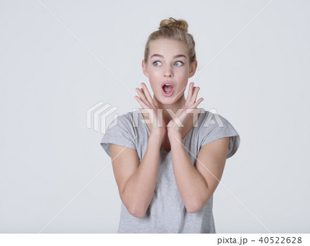 Young shocked woman on white background Young shocked woman on white background 40522628