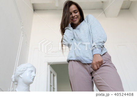 Smiling young woman in a gray sweatshirt. Mock-up. 40524408