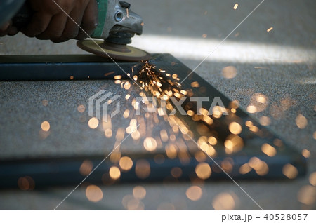The worker is welding metal part of table steel. The worker is welding metal part of table steel. 40528057