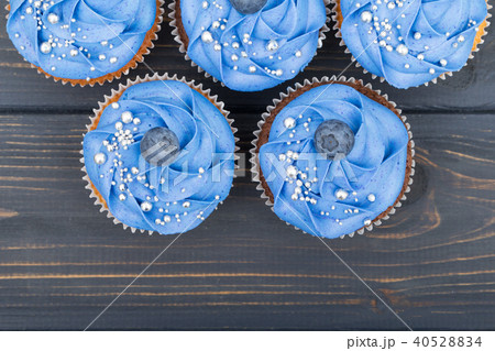 Tasty cupcakes on a white wooden table 40528834