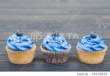 Tasty cupcakes on a white wooden table Tasty cupcakes on a white wooden table 40528838