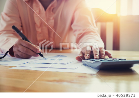 Asian Business woman using a calculator Asian Business woman using a calculator 40529573