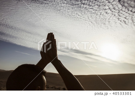 young man doing yoga outdoors 40533301