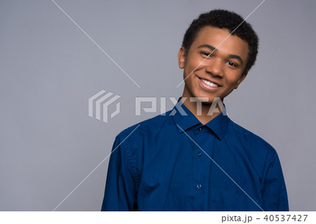 Happy African American teenager in denim shirt. Happy African American teenager in denim shirt. 40537427