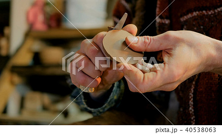 Professional male potter working in workshop, studio Professional male potter working in workshop, studio 40538063
