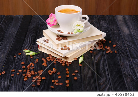 Cup of coffee on top of pile of books  40538453