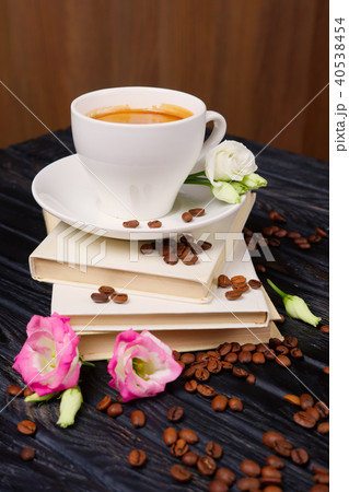 Cup of coffee on top of pile of books  40538454