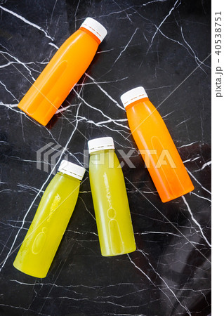 Bottles of cold-pressed juices on marble table Bottles of cold-pressed juices on marble table 40538751