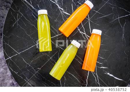 Bottles of cold-pressed juices on marble table Bottles of cold-pressed juices on marble table 40538752