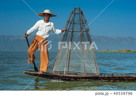 Burmese fisherman on boat catching fish. Myanmar 40539796