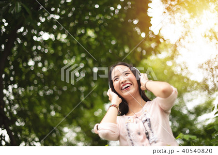 Asian girl listening to the music with headphone. 40540820