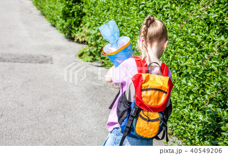 Little girl on her way to her first day of school Little girl on her way to her first day of school 40549206