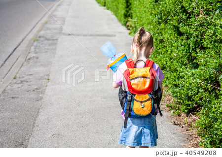 Little girl on her way to her first day of school Little girl on her way to her first day of school 40549208