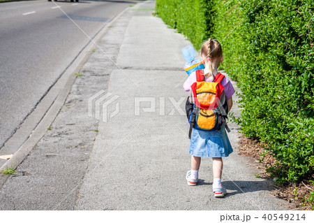 Little girl on her way to her first day of school Little girl on her way to her first day of school 40549214