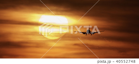 Beautiful sunset with airplane landing 40552748