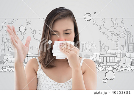 Asian woman in white dress catch her nose because of a bad smell 40553381