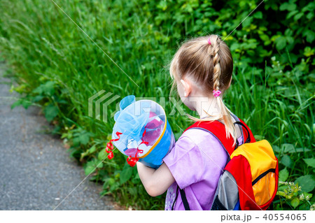 Little girl on her way to her first day of school Little girl on her way to her first day of school 40554065