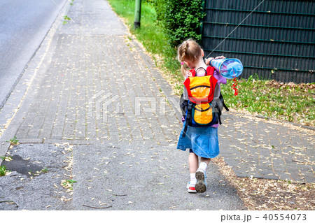 Little girl on her way to her first day of school Little girl on her way to her first day of school 40554073